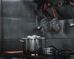 Stainless-steel cookware and utensils in a compact commercial kitchen