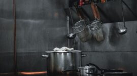 Stainless-steel cookware and utensils in a compact commercial kitchen
